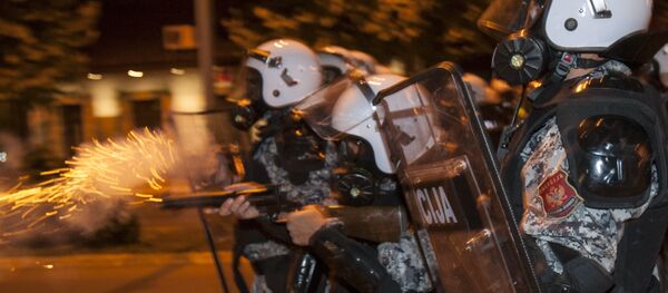 A riot policeman fires tear gas at protesters in front of the parliament building in Podgorica, Montenegro, October 24, 2015. - Sputnik International