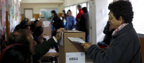 A woman casts her vote at a polling station in Buenos Aires A woman casts her vote at a polling station in Buenos Aires - Sputnik International