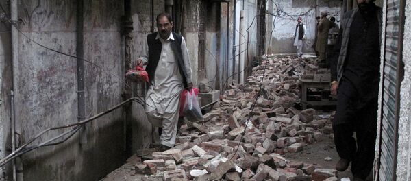 A man with his belongings walks past the rubble of a house after it was damaged by an earthquake in Mingora, Swat, Pakistan A man with his belongings walks past the rubble of a house after it was damaged by an earthquake in Mingora, Swat, Pakistan - Sputnik International