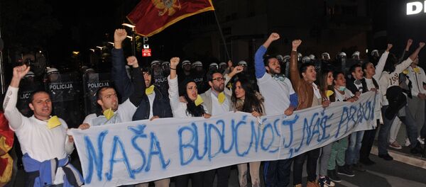 Montenegrin anti-government protesters carry a banner reading, Our future, our right during a protest in the capital Podgorica on October 24, 2015. - Sputnik International