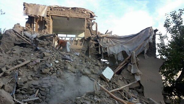 An Afghan man digs through the rubble of a damaged building after a powerful earthquake in Raman Kheel village in Panjshir valley - Sputnik International