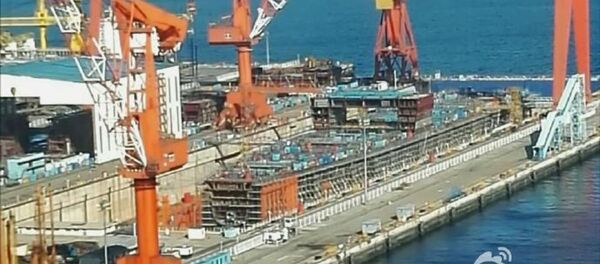 This hull under construction at Dalian Shipyard could be China's first indigenous aircraft carrier. This hull under construction at Dalian Shipyard could be China's first indigenous aircraft carrier. - Sputnik International
