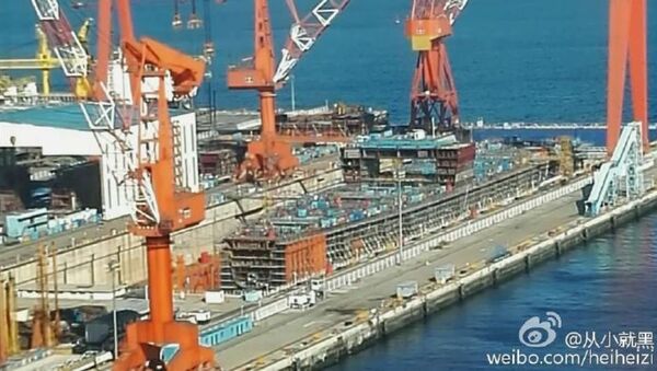 This hull under construction at Dalian Shipyard could be China's first indigenous aircraft carrier. - Sputnik International