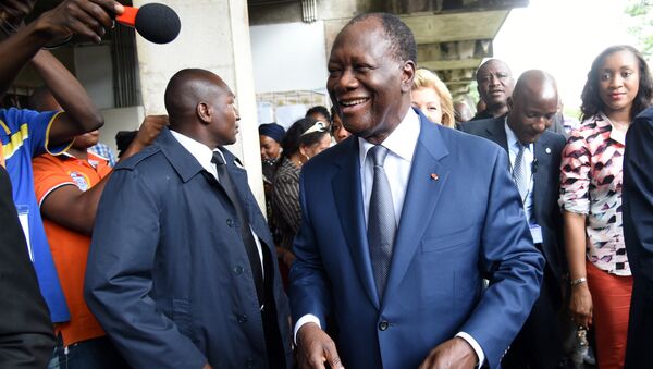 Incumbent Ivory Coast president Alassane Ouattara smiles to supporters as he leaves a polling station after voting in the Cocody residential district of Abidjan during Ivory Coast presidential elections - Sputnik International