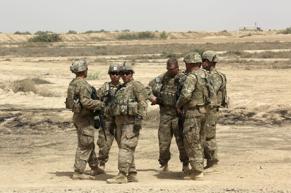 US soldiers prepare to participate in a training mission with Iraqi Army soldier, right, outside Baghdad, Iraq. (File) US soldiers prepare to participate in a training mission with Iraqi Army soldier, right, outside Baghdad, Iraq. (File) - Sputnik International
