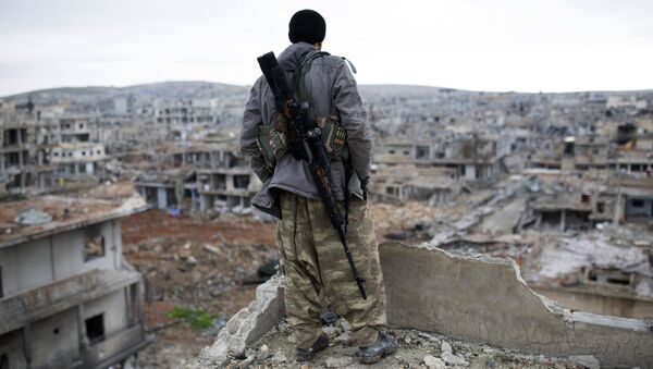 FILE - In this Jan. 30, 2015, file photo, a Syrian Kurdish sniper looks at the rubble in the Syrian city of Ain al-Arab, also known as Koban - Sputnik International