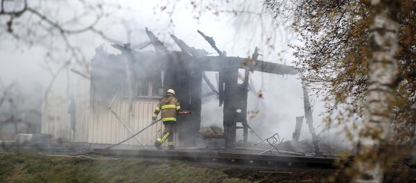 FILE - A Tuesday, Oct. 20, 2015 photo from files showing a firefighter working in the smoking remains of an accommodation home for asylum seekers near Munkedal in western Sweden FILE - A Tuesday, Oct. 20, 2015 photo from files showing a firefighter working in the smoking remains of an accommodation home for asylum seekers near Munkedal in western Sweden - Sputnik International