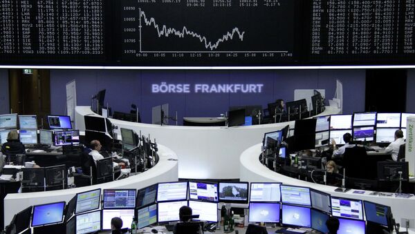 Traders are pictured at their desks in front of the DAX board at the stock exchange in Frankfurt, Germany, October 29, 2015 - Sputnik International
