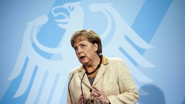 German Chancellor Angela Merkel  in front of Germany's heraldic eagle - Sputnik International