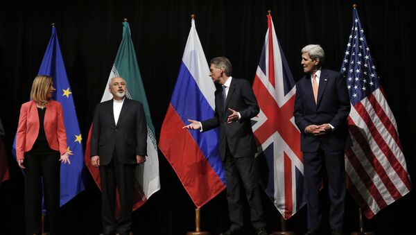 In this file photo, British Foreign Secretary Philip Hammond, second right, U.S. Secretary of State John Kerry, right, and European Union High Representative for Foreign Affairs and Security Policy Federica Mogherini, left, talk to Iranian Foreign Minister Mohammad Javad Zarif as the wait for Russian Foreign Minister Sergey Lavrov, not pictured, for a group picture at the Vienna International Center in Vienna, Austria - Sputnik International
