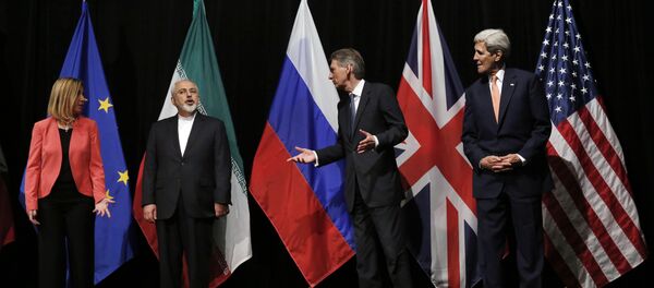 In this file photo, British Foreign Secretary Philip Hammond, second right, U.S. Secretary of State John Kerry, right, and European Union High Representative for Foreign Affairs and Security Policy Federica Mogherini, left, talk to Iranian Foreign Minister Mohammad Javad Zarif as the wait for Russian Foreign Minister Sergey Lavrov, not pictured, for a group picture at the Vienna International Center in Vienna, Austria In this file photo, British Foreign Secretary Philip Hammond, second right, U.S. Secretary of State John Kerry, right, and European Union High Representative for Foreign Affairs and Security Policy Federica Mogherini, left, talk to Iranian Foreign Minister Mohammad Javad Zarif as the wait for Russian Foreign Minister Sergey Lavrov, not pictured, for a group picture at the Vienna International Center in Vienna, Austria - Sputnik International