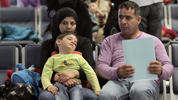 Syrian refugees wait to board a flight to Germany for temporary relocation, at Rafik Hariri International Airport in Beirut, Lebanon, Wednesday, Sept. 11, 2013. - Sputnik International