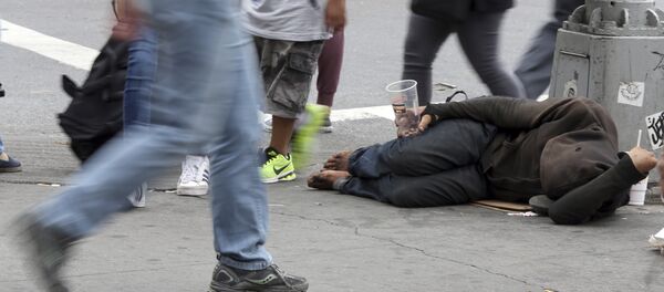 People walk past a homeless man asking for money on 14th Street, Friday, Sept. 4, 2015, in New York People walk past a homeless man asking for money on 14th Street, Friday, Sept. 4, 2015, in New York - Sputnik International