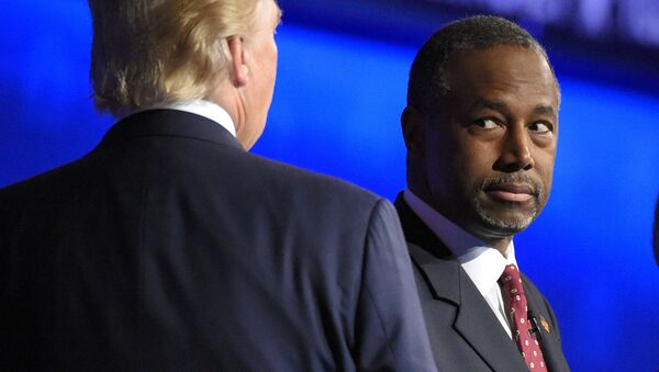 Ben Carson watches as Donald Trump takes the stage during the CNBC Republican presidential debate at the University of Colorado. - Sputnik International