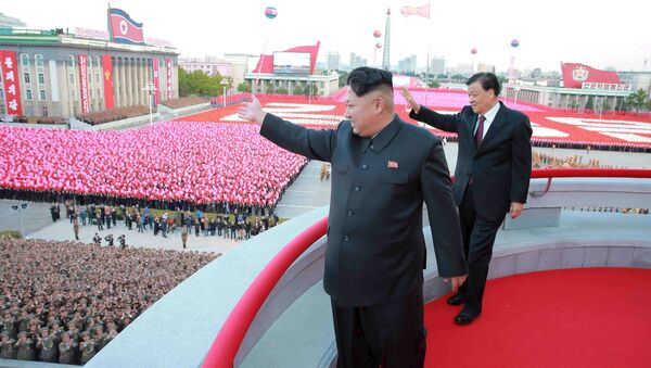 North Korean leader Kim Jong Un (L) and senior Chinese Communist Party official Liu Yunshan (R) wave during celebration of the 70th anniversary of the founding of the ruling Workers' Party of Korea, in this undated photo released by North Korea's Korean Central News Agency (KCNA) in Pyongyang on October 12, 2015 - Sputnik International