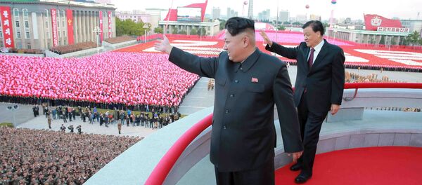 North Korean leader Kim Jong Un (L) and senior Chinese Communist Party official Liu Yunshan (R) wave during celebration of the 70th anniversary of the founding of the ruling Workers' Party of Korea, in this undated photo released by North Korea's Korean Central News Agency (KCNA) in Pyongyang on October 12, 2015 - Sputnik International