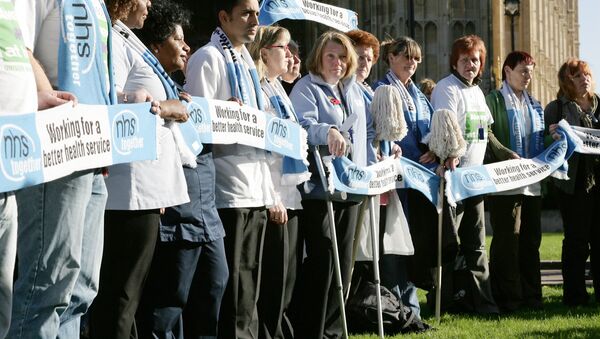 British National Health Service (NHS) staff gather outside Houses of Parliament in London to voice their feelings against potential staff cuts in hospitals, Wednesday, Nov. 1, 2006.. - Sputnik International