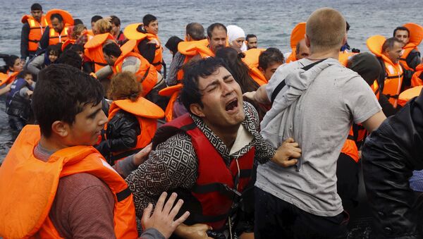 A Syrian refugee cries while disembarking from a flooded raft at a beach on the Greek island of Lesbos, after crossing a part of the Aegean Sea from the Turkish coast on an overcrowded raft, October 20, 2015 - Sputnik International
