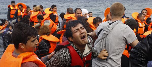A Syrian refugee cries while disembarking from a flooded raft at a beach on the Greek island of Lesbos, after crossing a part of the Aegean Sea from the Turkish coast on an overcrowded raft, October 20, 2015 A Syrian refugee cries while disembarking from a flooded raft at a beach on the Greek island of Lesbos, after crossing a part of the Aegean Sea from the Turkish coast on an overcrowded raft, October 20, 2015 - Sputnik International