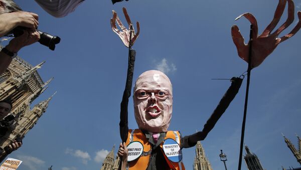 A protester carrying a puppet depicting Chris Grayling in central London, Tuesday, April 1, 2014. - Sputnik International