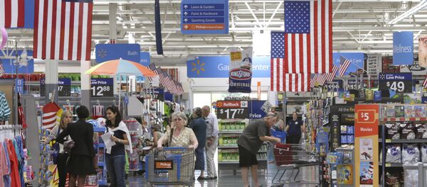 Customers shop on widened aisles at a Wal-Mart Supercenter store in Springdale, Ark., Thursday, June 4, 2015 Customers shop on widened aisles at a Wal-Mart Supercenter store in Springdale, Ark., Thursday, June 4, 2015 - Sputnik International