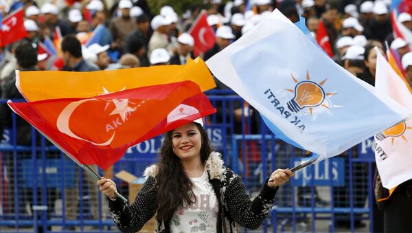 A supporter of the ruling AK Party waves national and party flags during an election rally in Ankara, Turkey, October 31, 2015 - Sputnik International