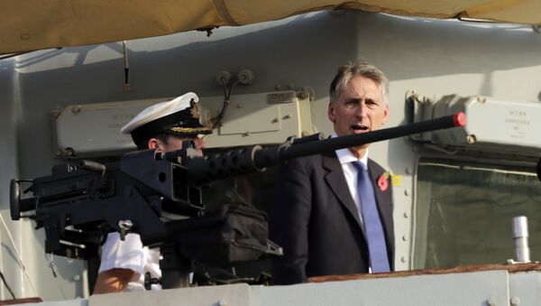 Former British Foreign Secretary Philip Hammond boards a British military ship docked in Manama, Bahrain after helping lay a cornerstone for a new British military base being built in Bahrain, Saturday, Oct. 31, 2015. Britain hasn't had a permanent military base in Bahrain since its former colony declared independence from Britain in 1971, though close ties have continued. - Sputnik International