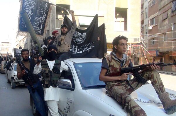 Islamic fighters from the al-Qaida group in the Levant, Al-Nusra Front, wave their movement's flag as they parade at the Yarmuk Palestinian refugee camp, south of Damascus, to denounce Israel’s military offensive on the Gaza Strip, on July 28, 2014. Islamic fighters from the al-Qaida group in the Levant, Al-Nusra Front, wave their movement's flag as they parade at the Yarmuk Palestinian refugee camp, south of Damascus, to denounce Israel’s military offensive on the Gaza Strip, on July 28, 2014. - Sputnik International
