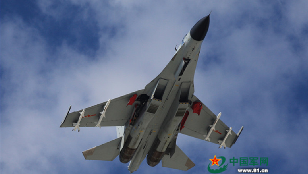 A J-11 fighter flies above the South China Sea on Oct. 30, 2015. An aviation division under the South China Sea Fleet of the Chinese PLA Navy carried out on Friday training on real air battle tactics. - Sputnik International