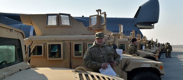 A Ukrainian serviceman holds a certificate at he stands next to an armoured car at Kiev airport on March 25, 2015 during a welcoming ceremony of the first US plane delivery of non-lethal aid, including 10 Humvee vehicles A Ukrainian serviceman holds a certificate at he stands next to an armoured car at Kiev airport on March 25, 2015 during a welcoming ceremony of the first US plane delivery of non-lethal aid, including 10 Humvee vehicles - Sputnik International