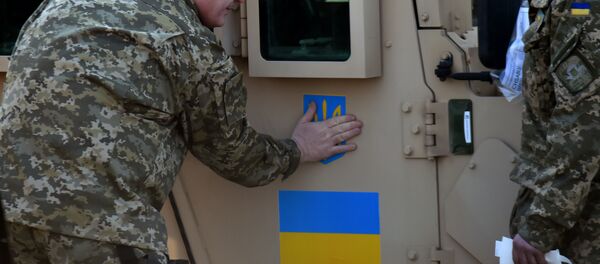 Ukrainian President Petro Poroshenko sticks an Ukrainian flag and the state emblem on an armoured vehicle at Kiev airport on March 25, 2015 during a welcoming ceremony of the first US plane delivery of non-lethal aid, including 10 Humvee vehicles Ukrainian President Petro Poroshenko sticks an Ukrainian flag and the state emblem on an armoured vehicle at Kiev airport on March 25, 2015 during a welcoming ceremony of the first US plane delivery of non-lethal aid, including 10 Humvee vehicles - Sputnik International