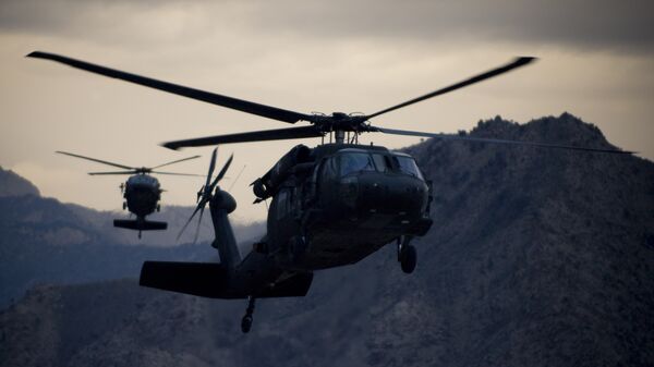 Two Army UH-60 Black Hawk helicopters prepare for landing at forward operating base Kalagush. - Sputnik International