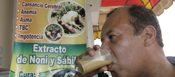 A man drinks a glass of frog juice in Lima, Peru. A man drinks a glass of frog juice in Lima, Peru. - Sputnik International