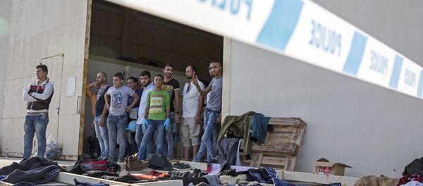Syrian migrants are temporarily housed at a warehouse after coming ashore at RAF base Akrotiri, Cyprus, Wednesday, Oct. 21, 2015. Syrian migrants are temporarily housed at a warehouse after coming ashore at RAF base Akrotiri, Cyprus, Wednesday, Oct. 21, 2015. - Sputnik International