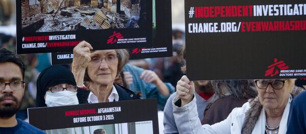 Supporters of Doctors Without Borders hold before and after images during a rally to mark the one-month anniversary of a U.S. military strike on its trauma center in Afghanistan. Supporters of Doctors Without Borders hold before and after images during a rally to mark the one-month anniversary of a U.S. military strike on its trauma center in Afghanistan. - Sputnik International