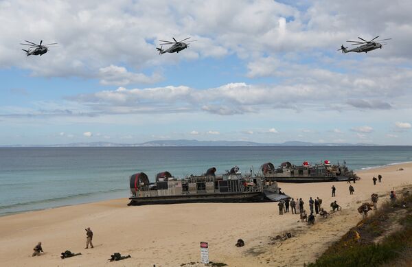 U.S. navy helicopters fly over U.S. Navy hovercraft during the NATO Trident Juncture exercise 2015 at Raposa Media beach in Pinheiro da Cruz, south of Lisbon - Sputnik International