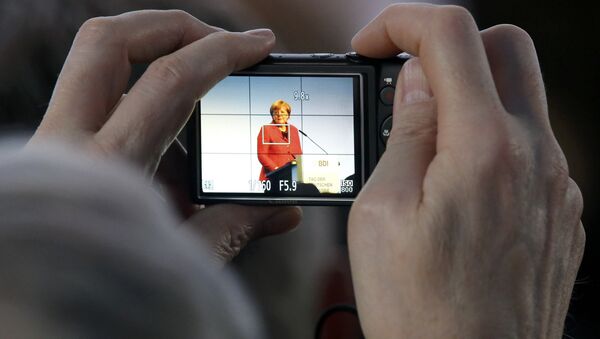 A participant takes a picture as German Chancellor Angela Merkel delivers her speech at the Federation of German Industry (BDI) conference in Berlin, Germany, November 3, 2015. - Sputnik International