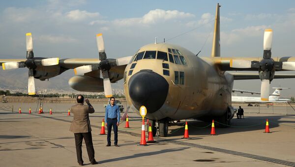 Iranians take pictures in front of a C-130 plane in an exhibition of achievements and equipment of Iran's air force in Tehran, Iran, Wednesday, Sept. 23, 2015 - Sputnik International