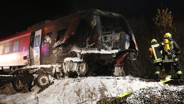 Rescuers gather at a partially burnt regional train after an accident on the railway near the Bavarian city of Freihung, southern Germany, on late November 5, 2015. - Sputnik International