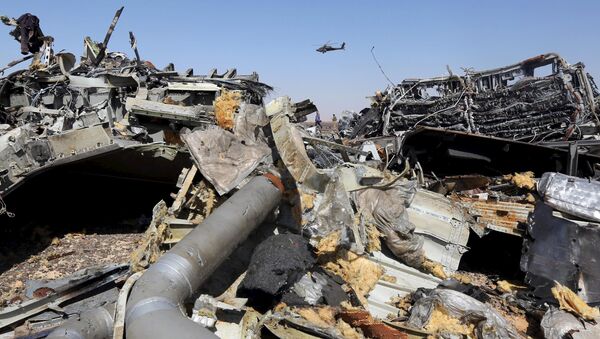 he remains of a Russian airliner are seen as an Egyptian military helicopter flies over the crash site in al-Hasanah area at El Arish city, north Egypt, November 1, 2015 - Sputnik International