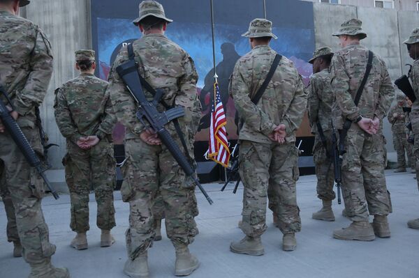U.S. service members stand in front of a U.S. flag during a ceremony on the thirteenth anniversary of the 9/11 terrorist attacks in front of the World Trade Center Memorial at Bagram Airfield, Afghanistan, Thursday, Sept. 11, 2014 U.S. service members stand in front of a U.S. flag during a ceremony on the thirteenth anniversary of the 9/11 terrorist attacks in front of the World Trade Center Memorial at Bagram Airfield, Afghanistan, Thursday, Sept. 11, 2014 - Sputnik International