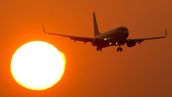 A Boeing 737 flies at the airport Stuttgart, southern Germany, as sun downs on March 14, 2014 - Sputnik International