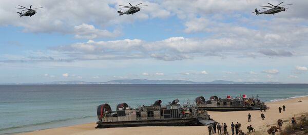 FILE - In this Oct. 20, 2015 file photo, U.S. navy helicopters fly over U.S. Navy hovercraft during the NATO Trident Juncture exercise 2015 at Raposa Media beach in Pinheiro da Cruz, south of Lisbon - Sputnik International