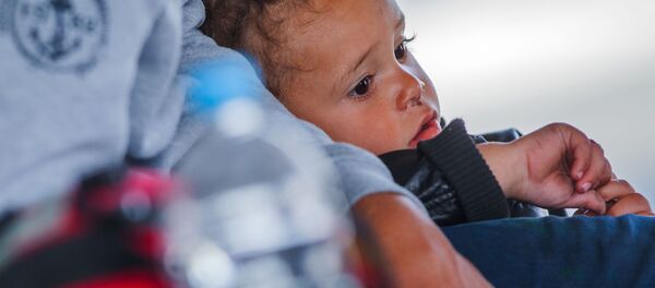 A refugee child waits for a ferry to Sweden at the harbor in Rostock, northeastern Germany, Monday, Sept. 14, 2015. A refugee child waits for a ferry to Sweden at the harbor in Rostock, northeastern Germany, Monday, Sept. 14, 2015. - Sputnik International