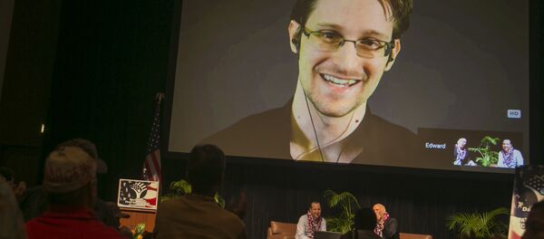 National Security Agency leaker Edward Snowden appears on a live video feed broadcast from Moscow at an event sponsored by the ACLU Hawaii in Honolulu on Saturday, Feb. 14, 2015 - Sputnik International