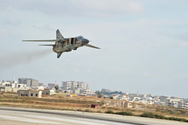 The Soviet-made MiG-23 fighter of the Syrian Air Force flies over the Hama airbase - Sputnik International
