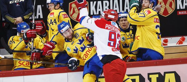 Russia's Nikolai Prokhorkin (center R) tackles Sweden's Jonas Junland (centre L) to the boards during their Euro Hockey Tour Karjala Cup match in Helsinki, Finland, November 7, 2015 - Sputnik International