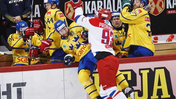 Russia's Nikolai Prokhorkin (center R) tackles Sweden's Jonas Junland (centre L) to the boards during their Euro Hockey Tour Karjala Cup match in Helsinki, Finland, November 7, 2015 - Sputnik International