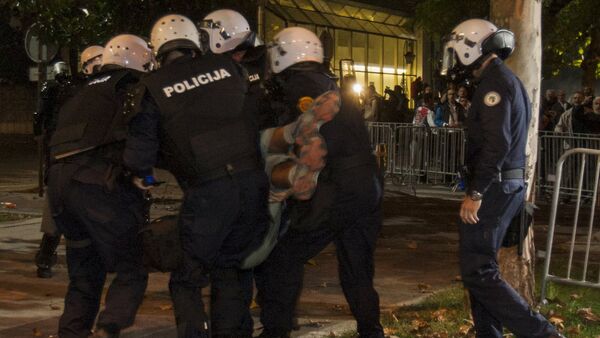 Riot police evacuate an injured demonstrator during protests in the capital Podgorica, Montenegro, October 18, 2015 - Sputnik International
