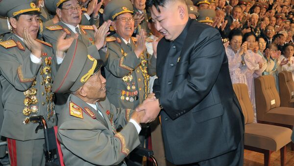In this undated photo released by the Korean Central News Agency and distributed in Tokyo by the Korea News Service Wednesday, Aug. 1, 2012, North Korean leader Kim Jong Un, front right, shakes hands with war veteran Ri Ul Sol during a ceremony commemorating the Korean War armistice at an undisclosed place in North Korea - Sputnik International
